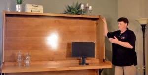 Richard Abbey demonstrates one of his bed products, the hidden desk bed